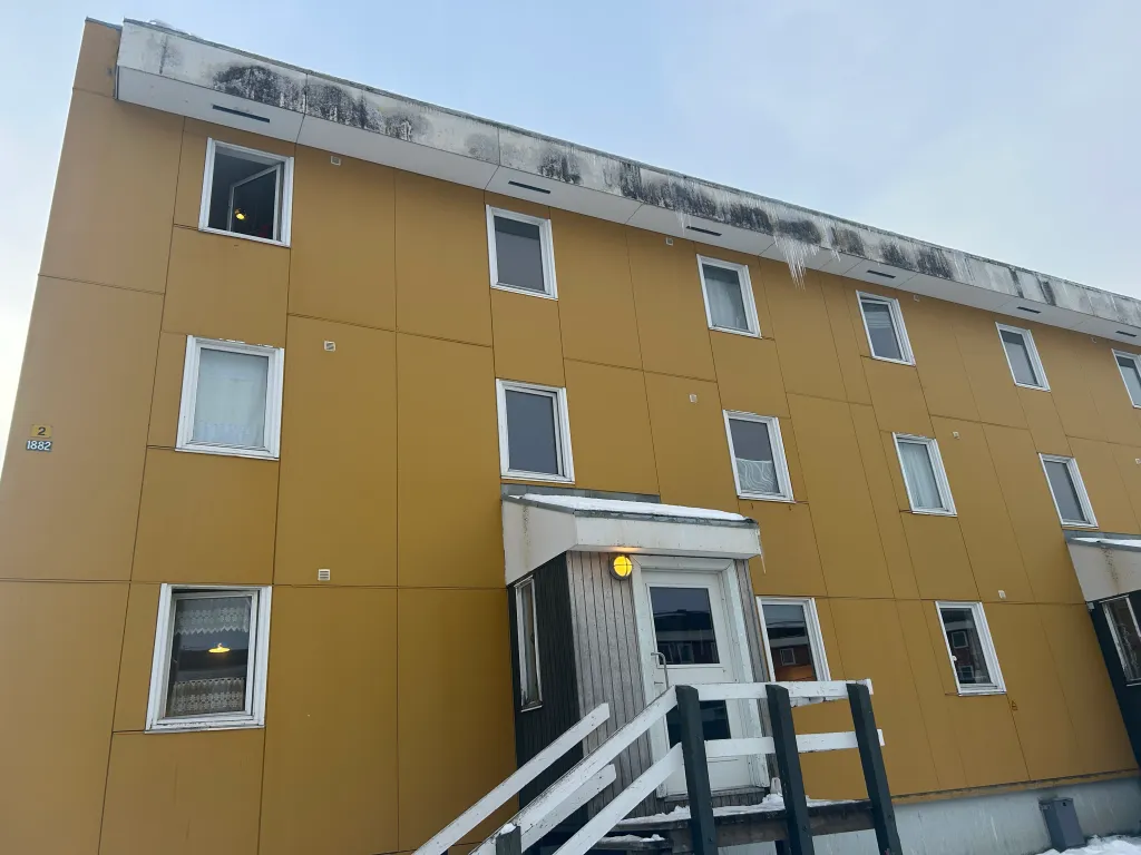 A large yellow apartment building in Nuuk, Greenland.