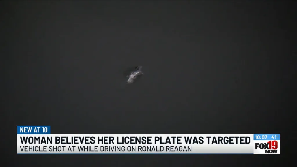 Bullet hole on a dark surface, with news text overlays about a woman believing her license plate was targeted.