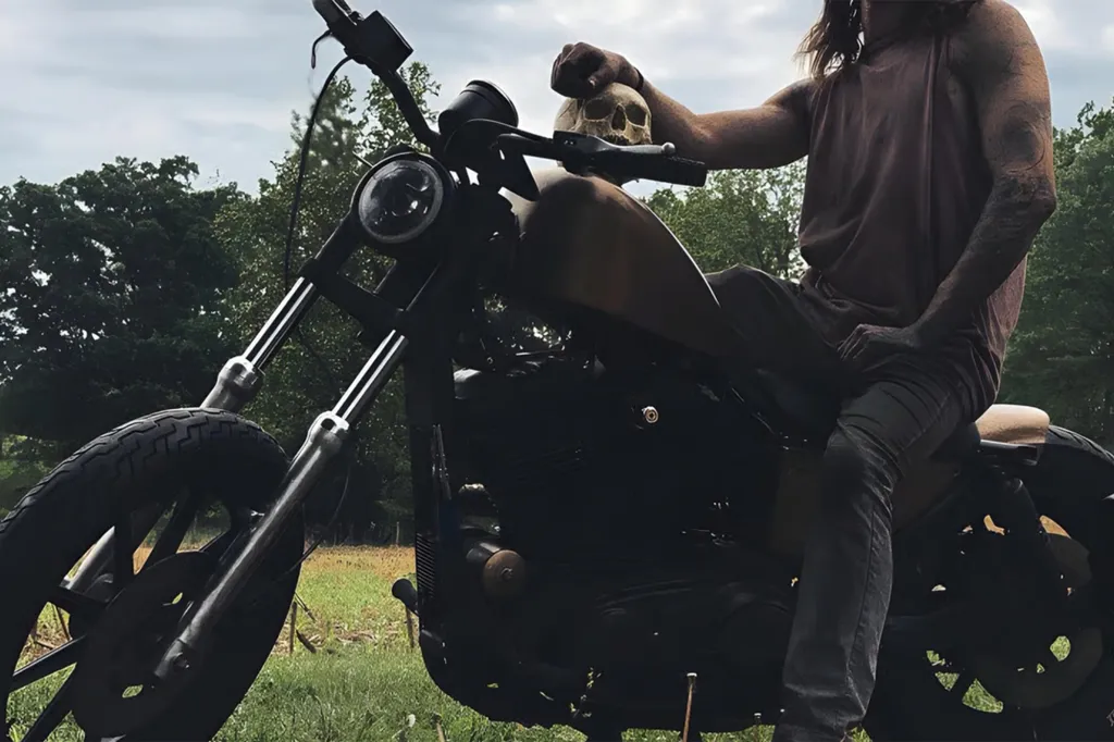 Jonathan Gerlach poses on a motorcycle with what appears to be a human skull.