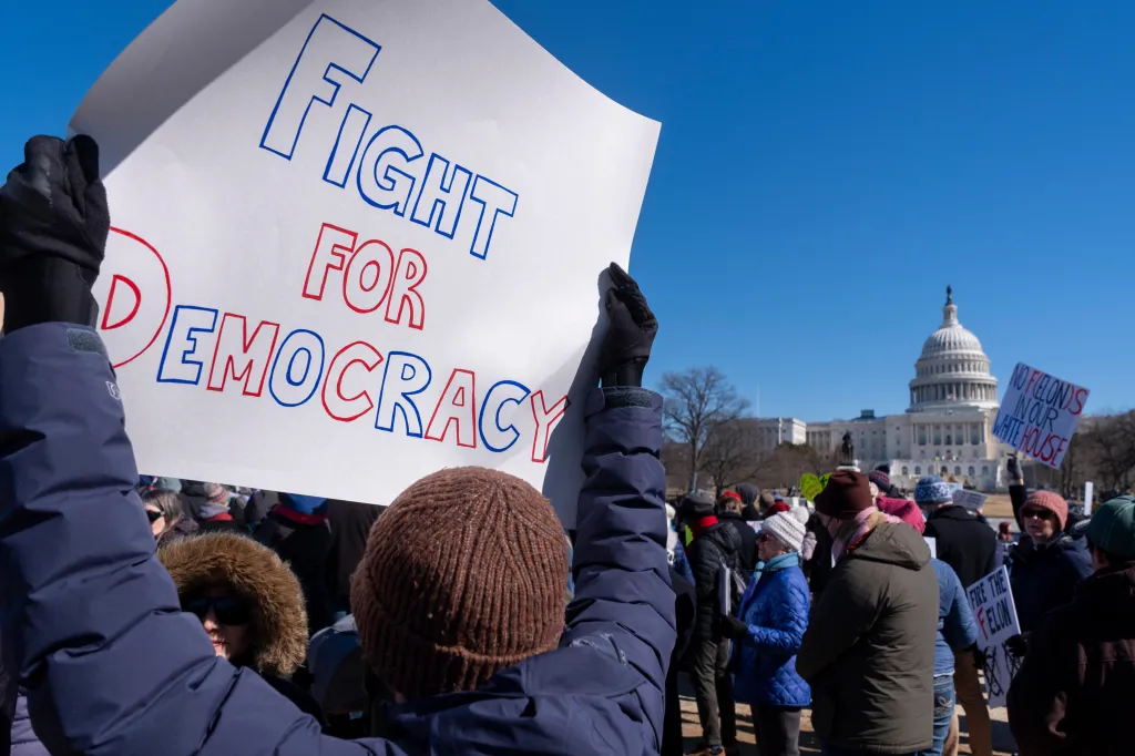 A protester holds a sign that reads 