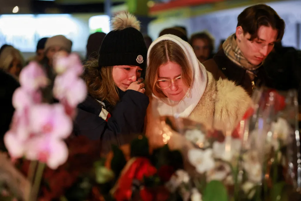 People crying outside Le Constellation bar after a New Year's Eve explosion and fire.