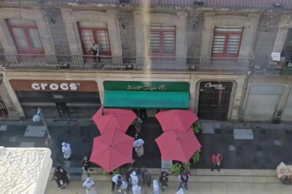People standing outside a building during an earthquake.