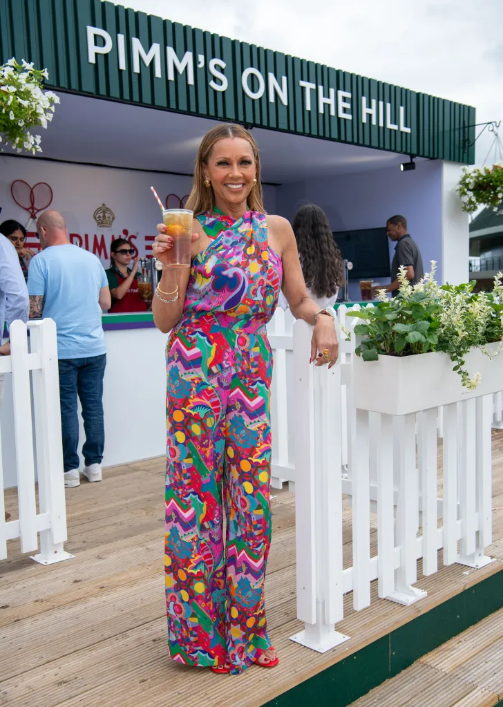 Vanessa Williams poses with a Pimm's drink at Wimbledon.