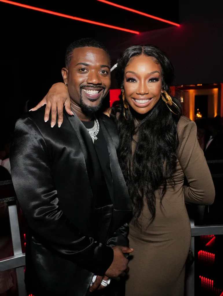 Ray J and Brandy smiling and posing for a photo.