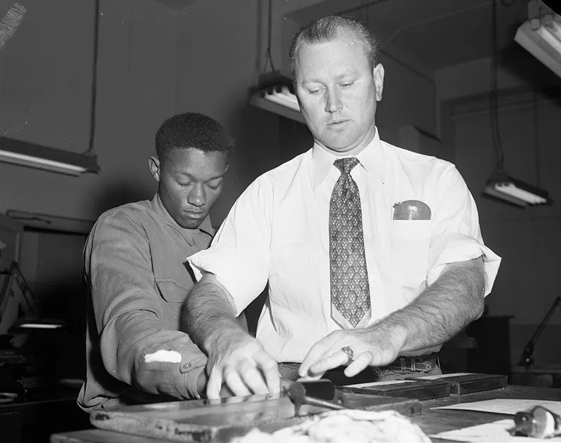 Tommy Lee Walker being fingerprinted after his arrest in January 1954.