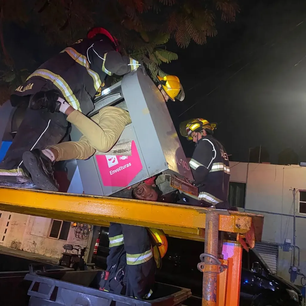 Firefighters rescue a man stuck in a garbage container in Guadalajara, Mexico.
