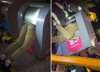 Man rescued after getting stuck in anti-vandal trash container with just his legs dangling out