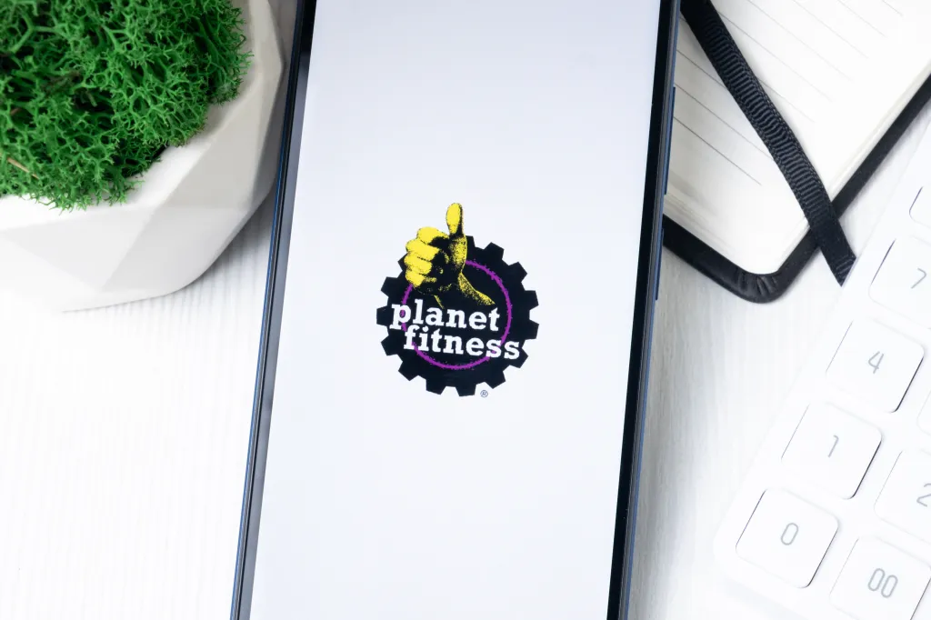 Planet Fitness logo on a phone screen.