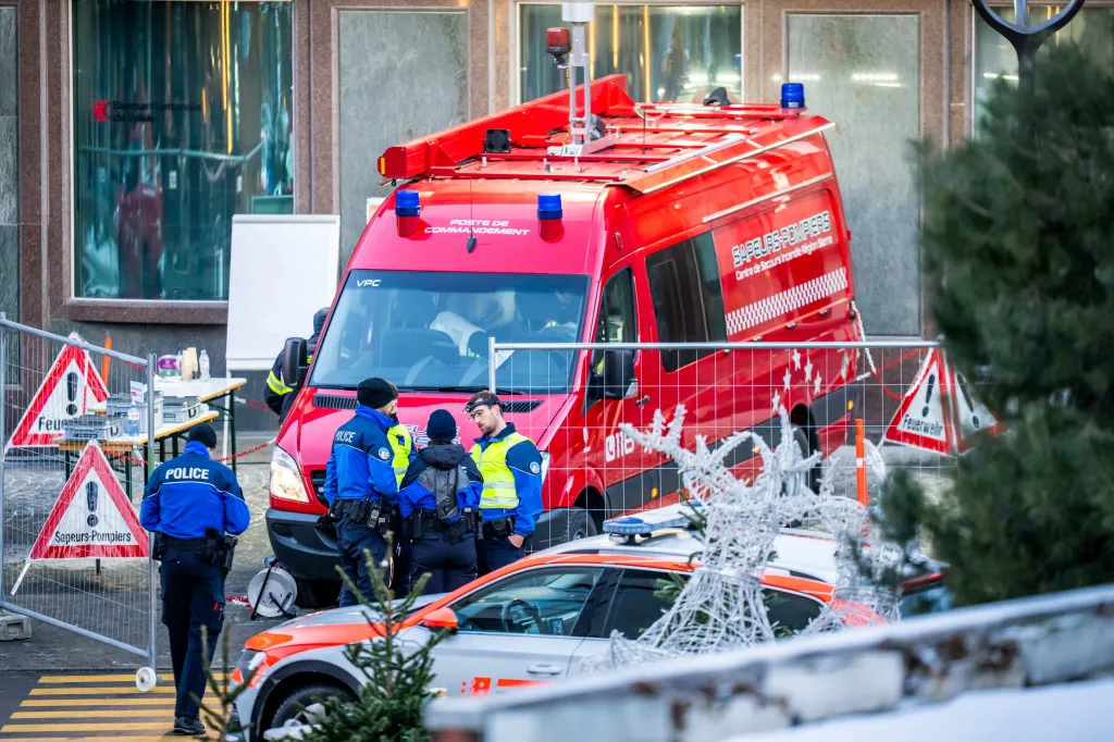 Police officers and rescuers stand next to an emergency vehicle outside Le Constellation in Crans Montana, Switzerland, on Jan. 1, 2026.