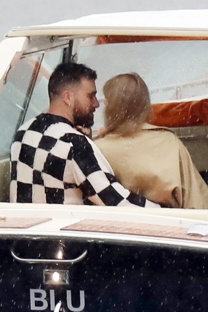 Taylor Swift and Travis Kelce embracing on a boat in Lake Como.