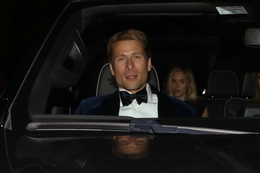 Glen Powell in a tuxedo, seen in a car with Michelle Randolph after the Golden Globes.