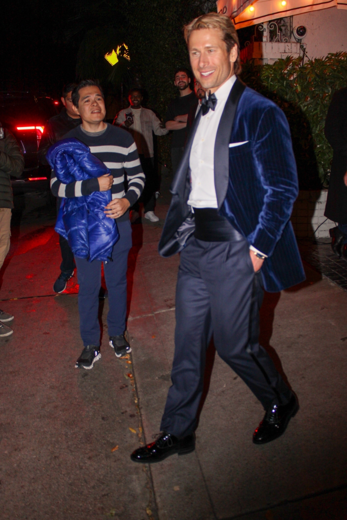Glen Powell leaving a Golden Globes after-party with his parents.