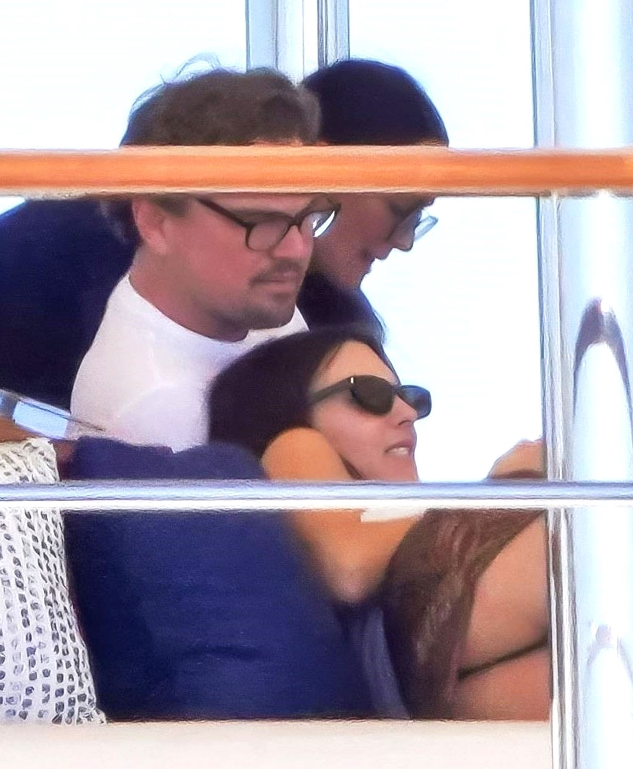 Leonardo DiCaprio and Vittoria Ceretti relaxing on a yacht.