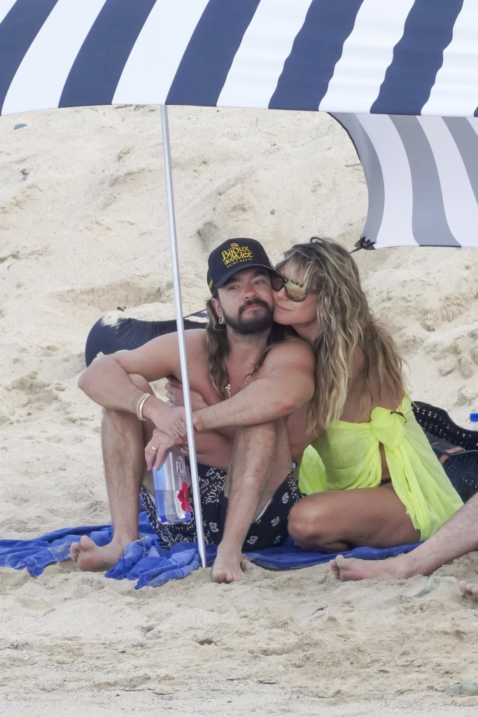 Heidi Klum and Tom Kaulitz relaxing on Saline Beach under an umbrella.