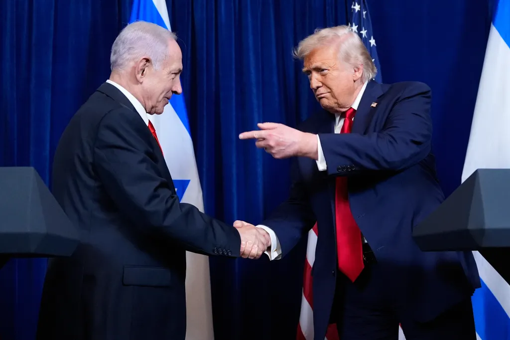 President Donald Trump shakes hands with Israel's Prime Minister Benjamin Netanyahu during a news conference at Mar-a-Lago, Monday, Dec. 29, 2025, in Palm Beach, Fla. 
