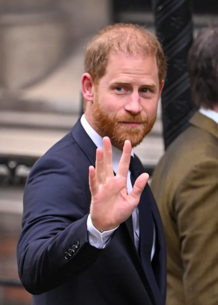 Prince Harry waves as he arrives at the Royal Courts of Justice.