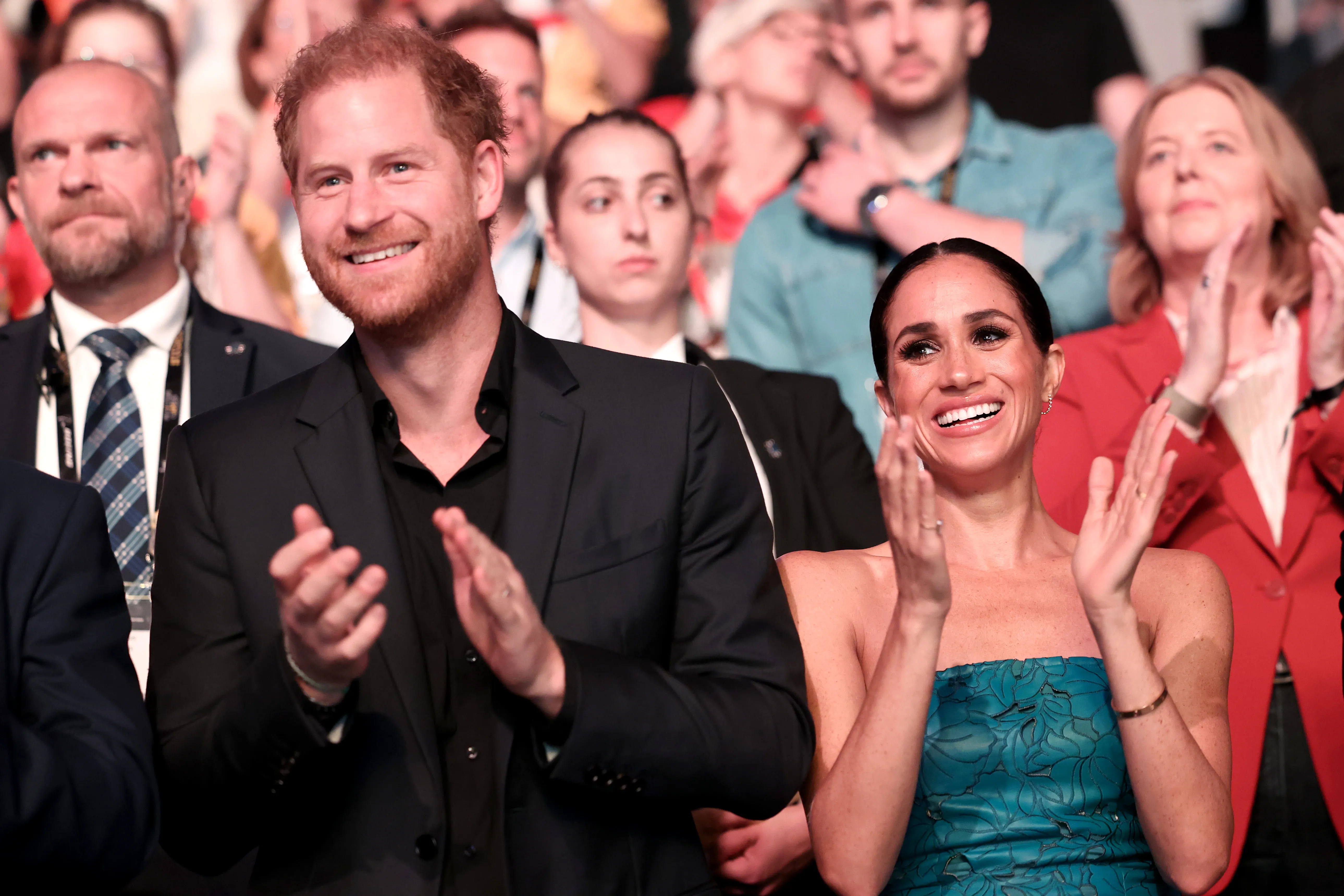 Prince Harry and Meghan Markle applauding during the Invictus Games closing ceremony.