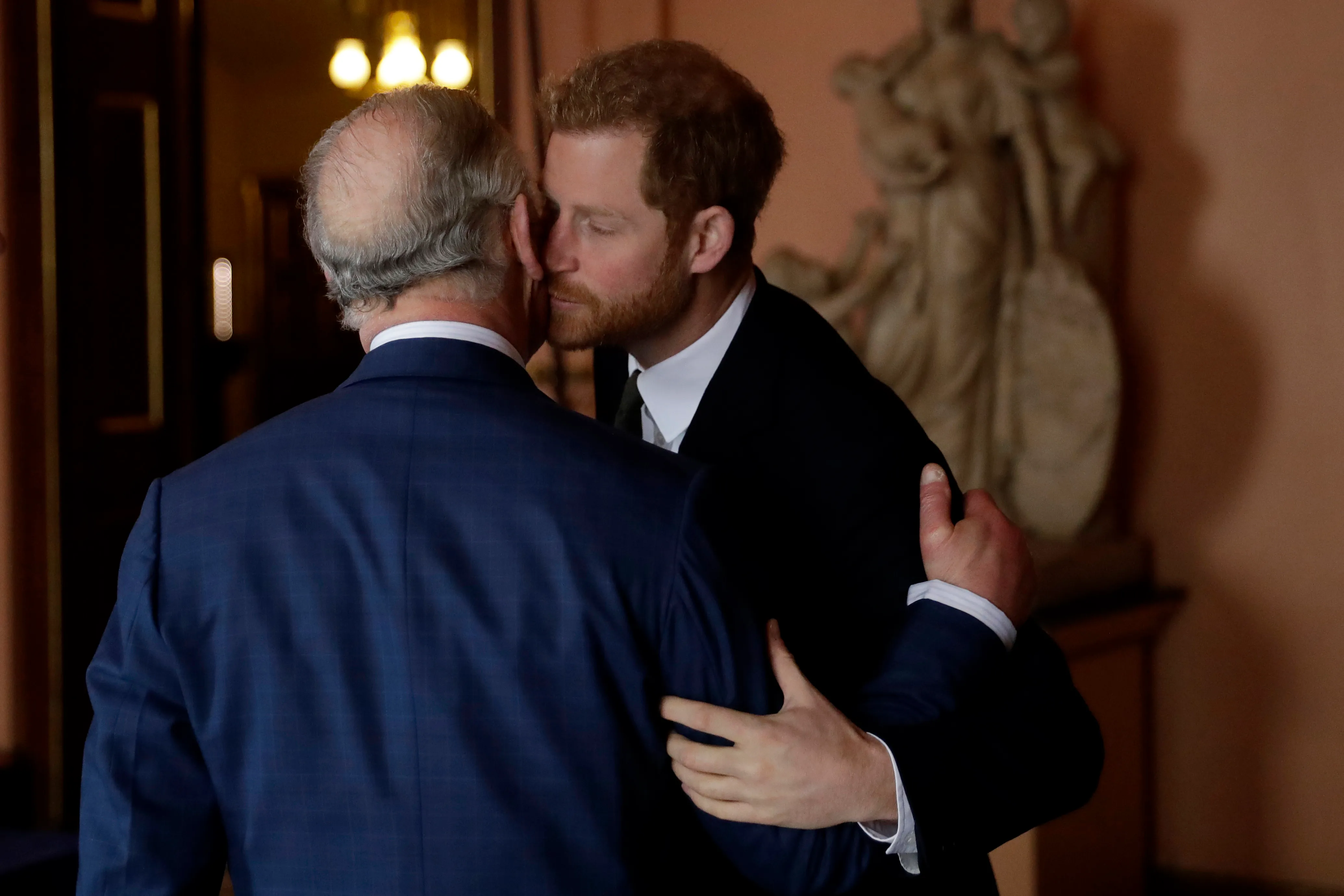 Prince Harry embracing Prince Charles at the International Year of the Reef 2018 meeting.
