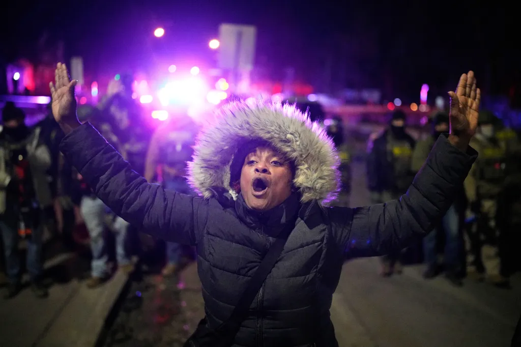 A protester yells in front of law enforcement after an illegal immigrant was shot in Minneapolis on Jan. 14, 2026.