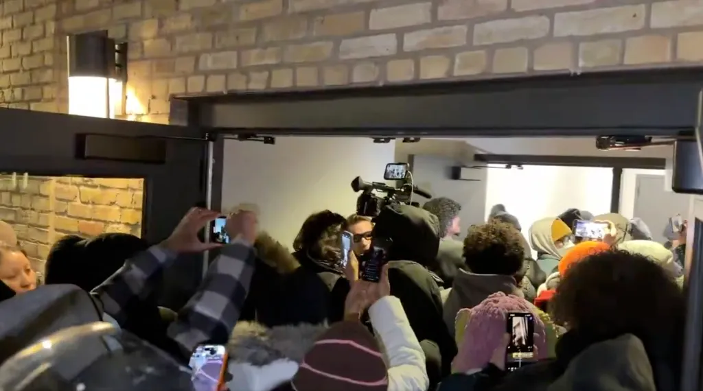 Protesters surround a Minneapolis hotel believed to be housing federal agents on Jan. 9, 2026.