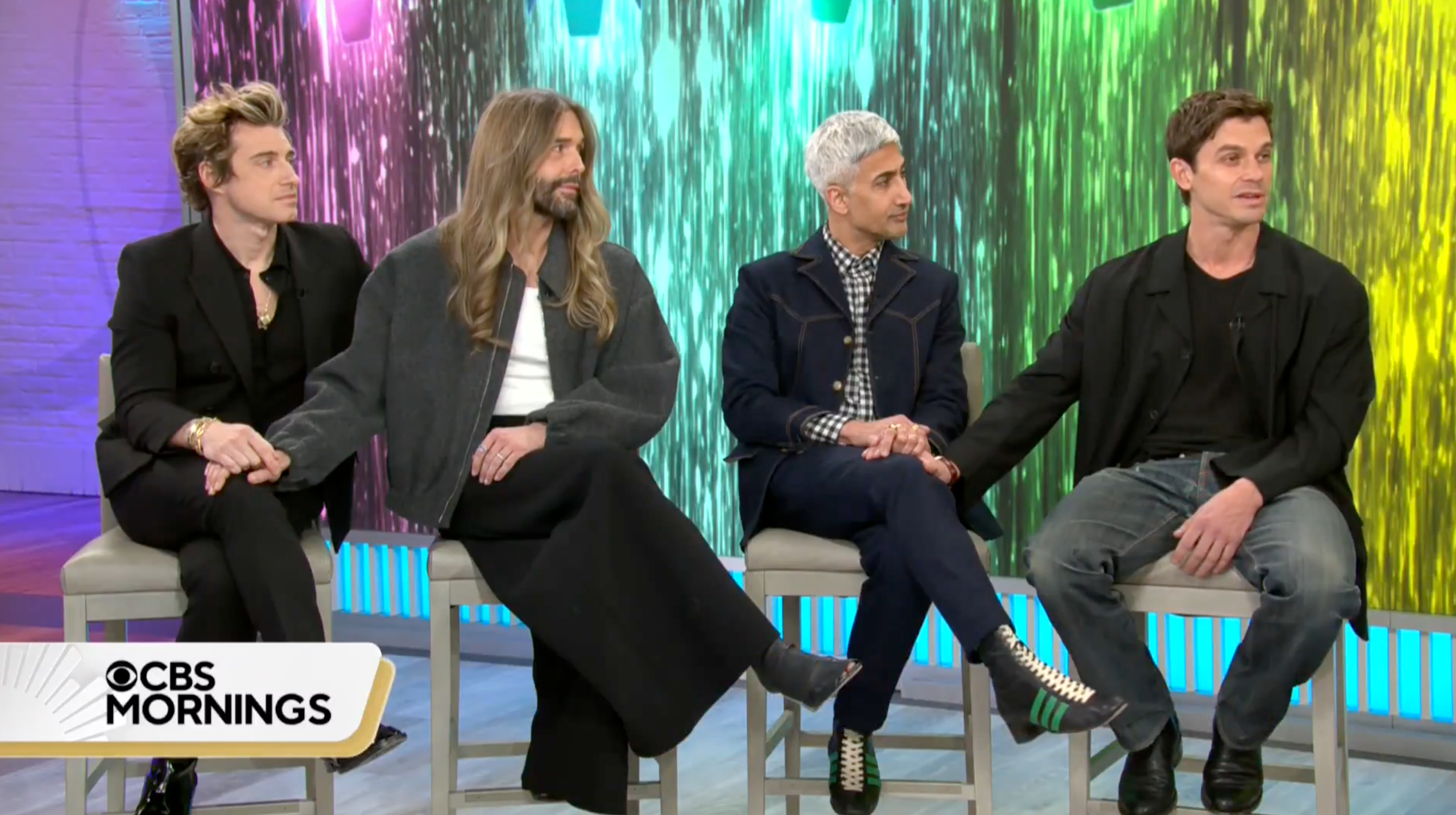 The cast of Queer Eye: Jonathan van Ness, Jeremiah Brent, Tan France, and Antoni Porowski, sitting on stools during an interview on CBS Mornings.
