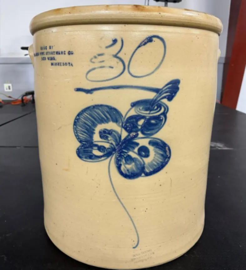 Red Wing Stoneware Company 30-gallon crock with blue flower design.