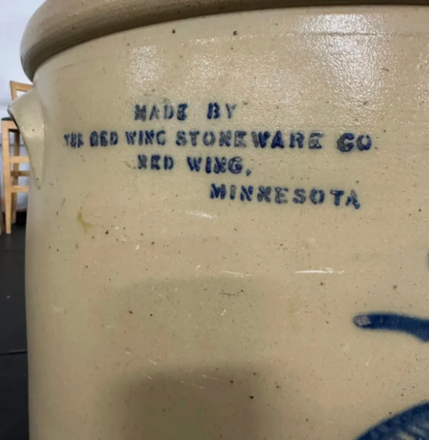 A close-up of a stoneware crock that reads 