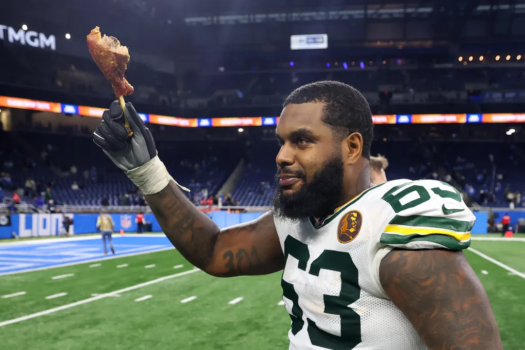 Rasheed Walker of the Green Bay Packers holds up a turkey leg after a win.