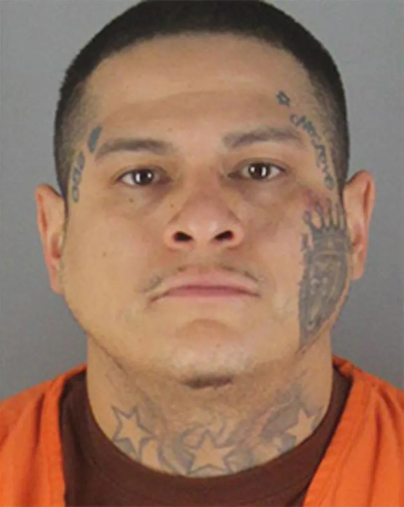 Mugshot of Raul Gutierrez, 33, with face and neck tattoos.