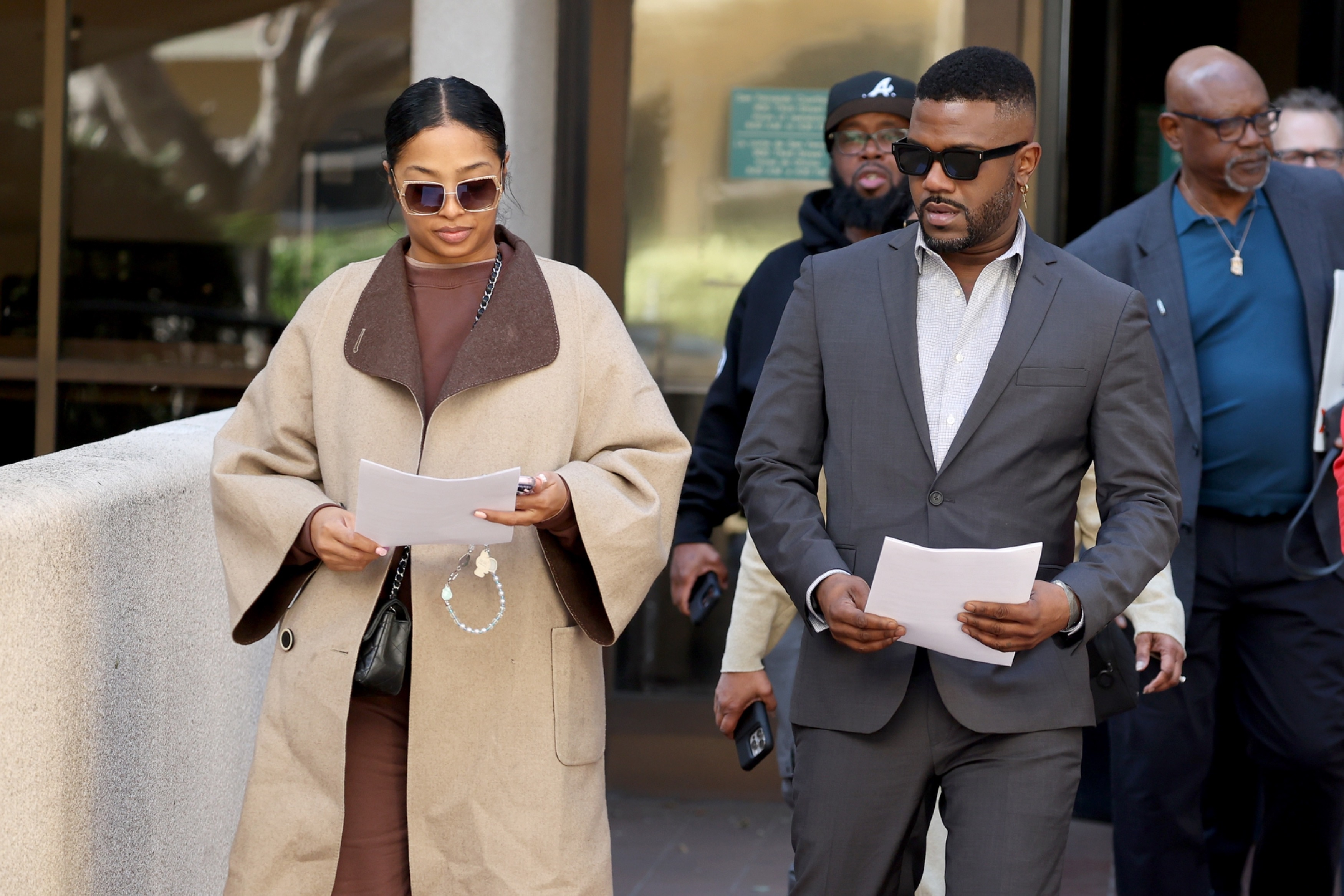 Ray J and Princess Love exit a Los Angeles court holding papers.