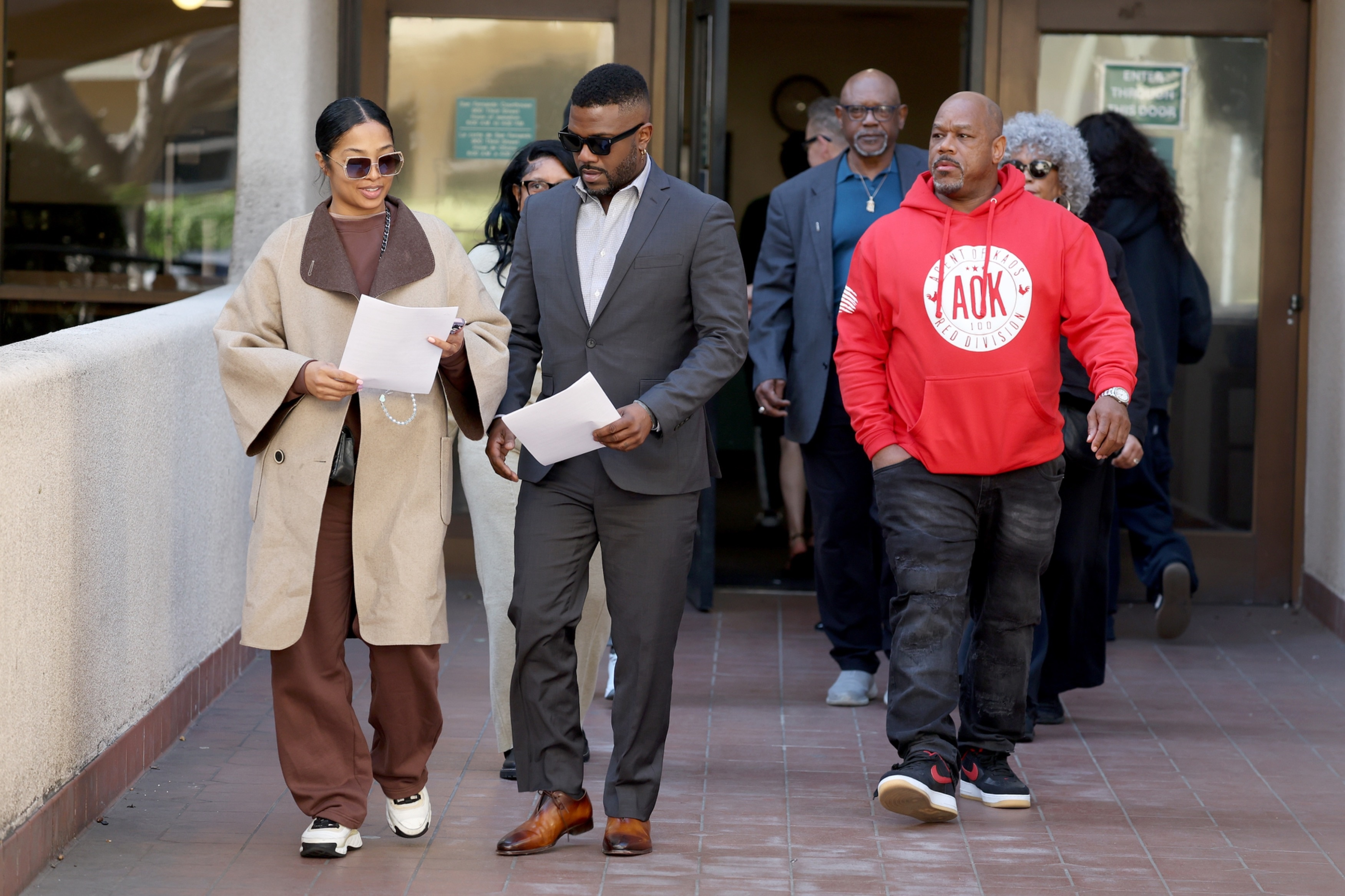 Ray J, Princess Love, and Sonja Norwood walk out of a courthouse.