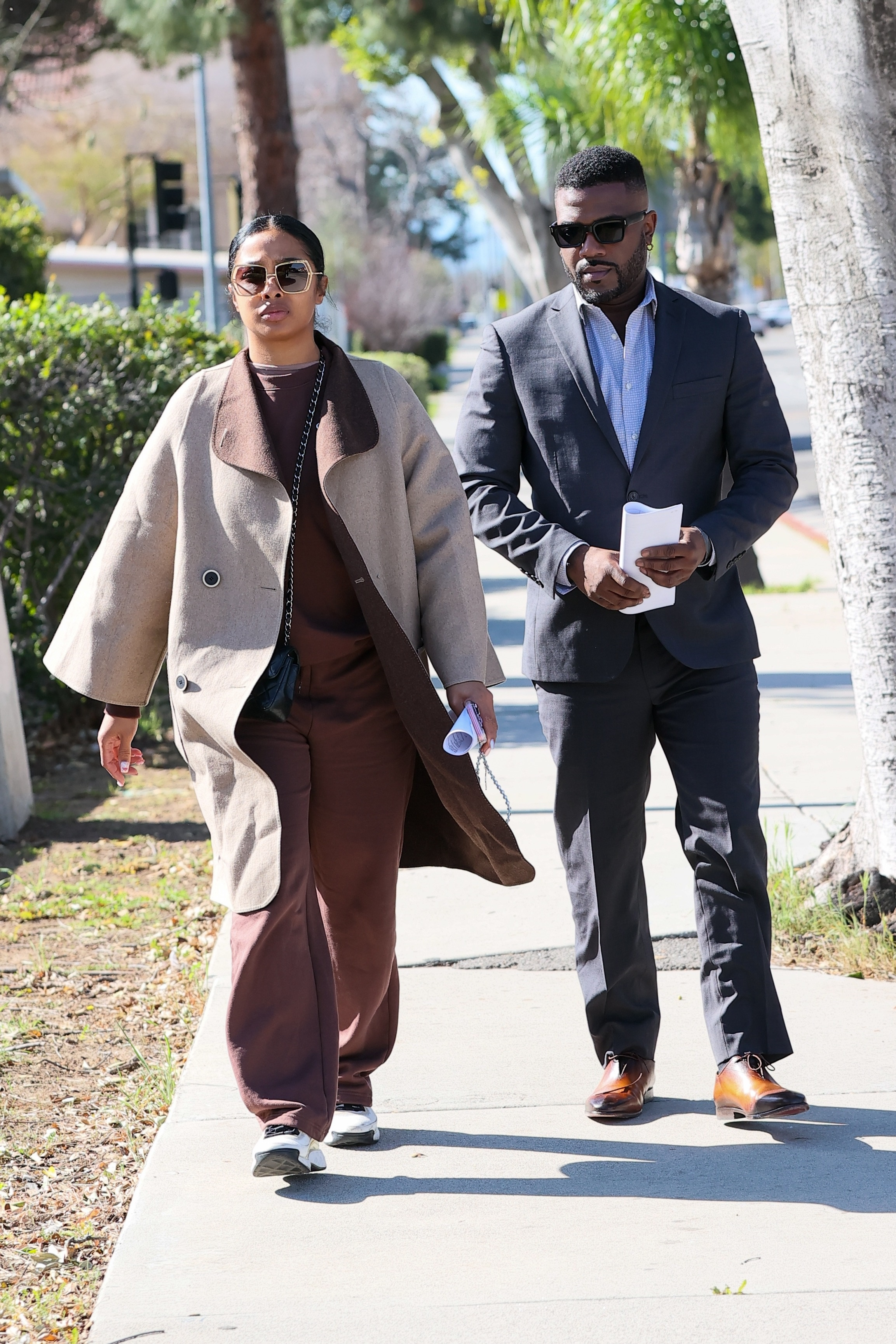 Ray J and Princess Love walk side-by-side after a court hearing.