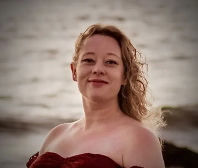 Renee Nicole Good, a white woman with curly blonde hair, wearing a red strapless dress, smiles at the camera with water in the background.
