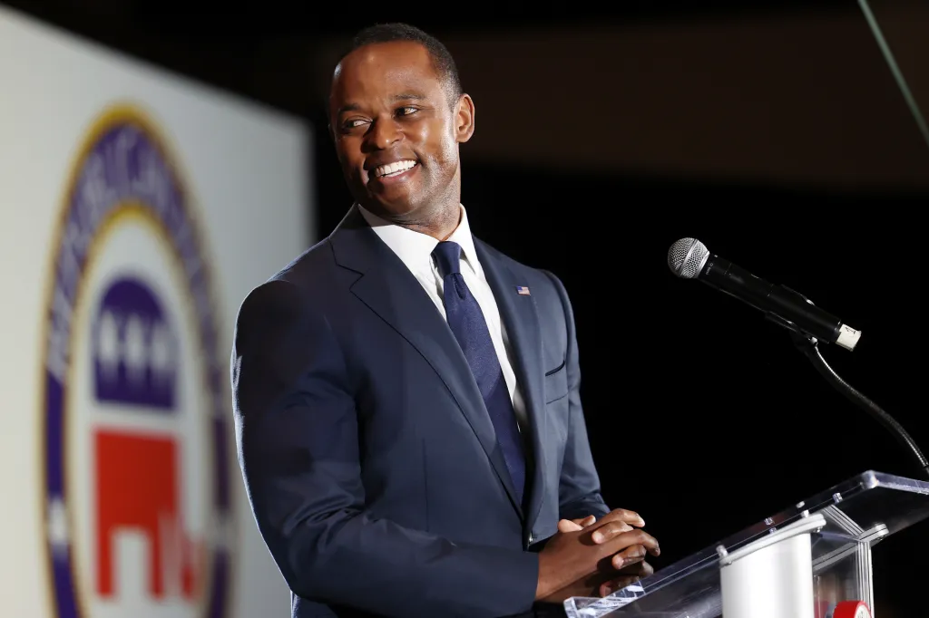 Republican gubernatorial candidate Daniel Cameron smiles at a podium during an election night watch party.
