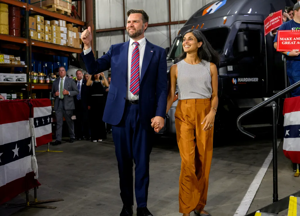 Sen. J.D. Vance (R-OH) walks on stage with his wife, Usha before speaking at a rally at trucking company, Team Hardinger on August 28, 2024 in Erie, Penn.