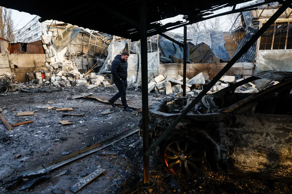 A resident inspects a compound of car workshop and garage hit during Russian overnight drone and missile strikes, amid Russia's attack on Ukraine, in Kyiv, Ukraine January 24, 2026. 