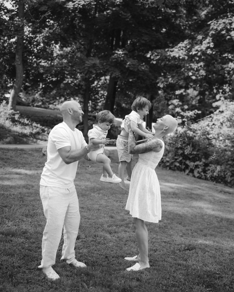 Family playing with two children in a park.