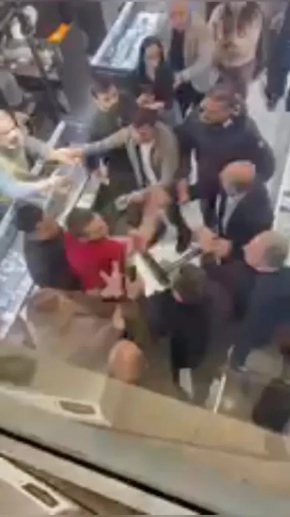 A group of men brawl in what appears to be a jewelry store.