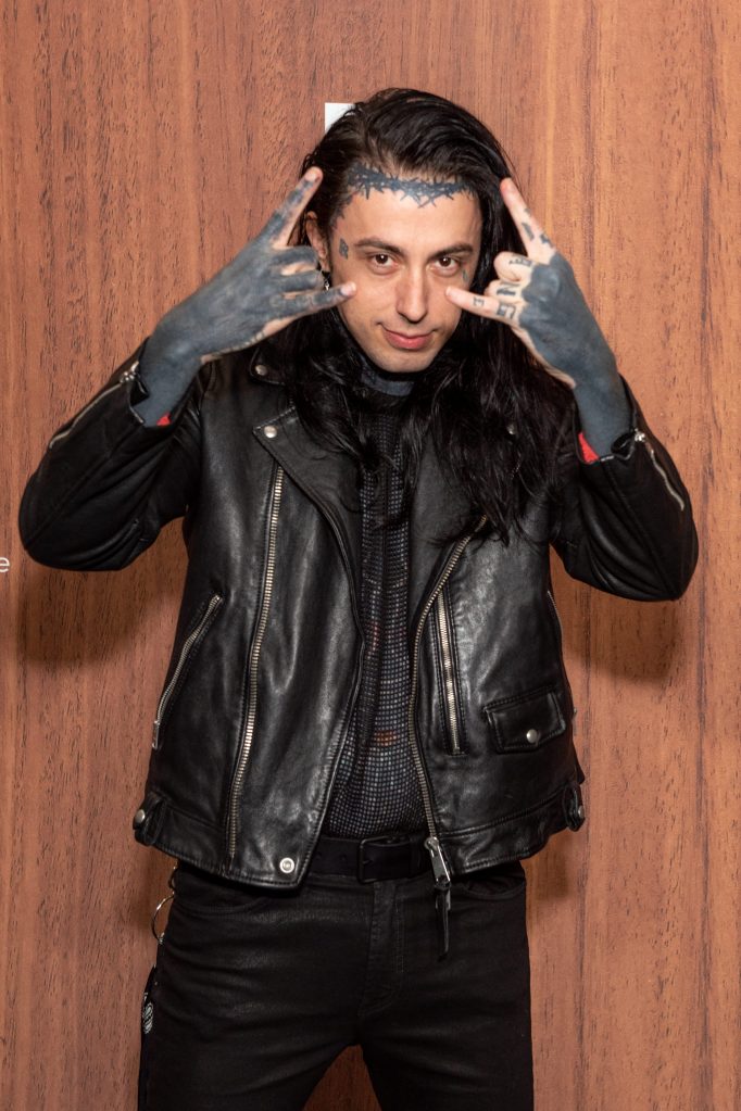 Ronnie Radke making rock-and-roll hand gestures.