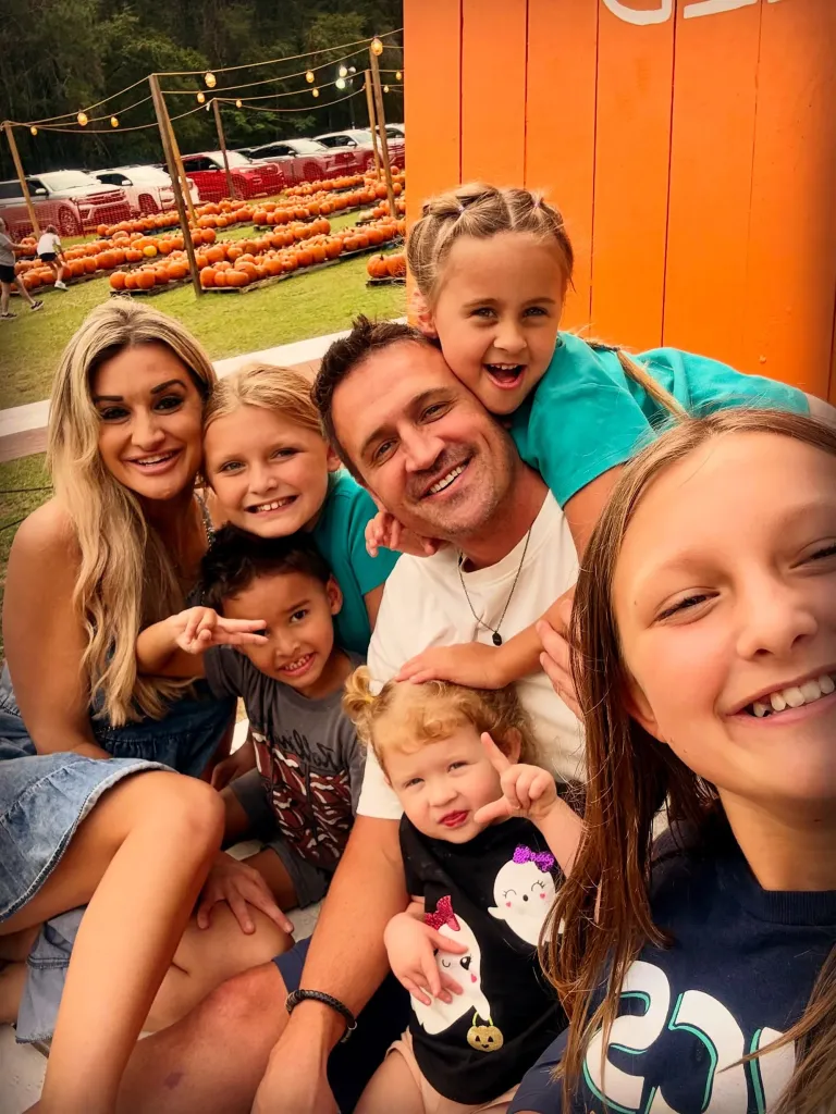 Ryan Lochte and his new girlfriend pose with their respective kids in front of a pumpkin patch.