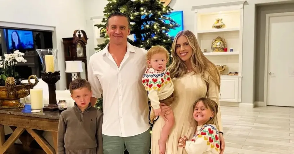 Ryan Lochte, his ex-wife Kayla, and their children pose in front of a Christmas tree.