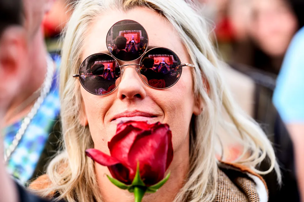 Grateful dead fan Sarah Black holds a rose during a public memorial for Bob Weir.