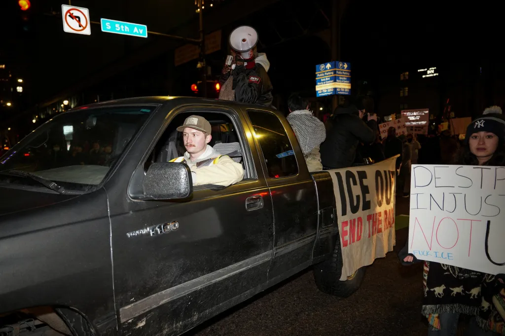 Protesters yell into a megaphone from the bed of a truck in Minneapolis, Minnesota.