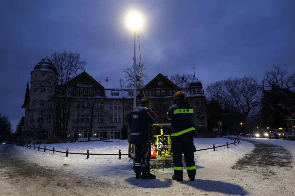 Workers setting up a street light with a power generator in southern Berlin.