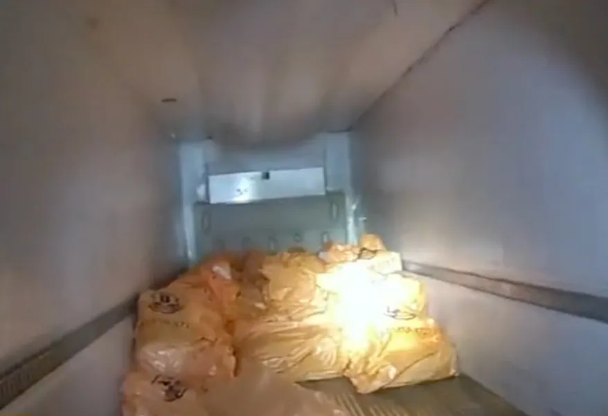 Orange bags of stolen jewelry inside a Brink's truck.