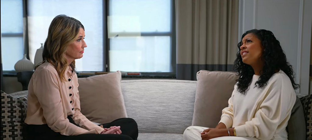 Sheinelle Jones, in a cream sweater and pants, and Savannah Guthrie, in a pink shirt, having a candid conversation.