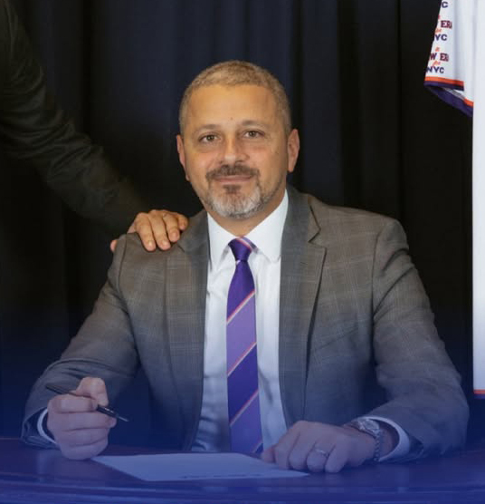 Sherif Soliman signing documents.
