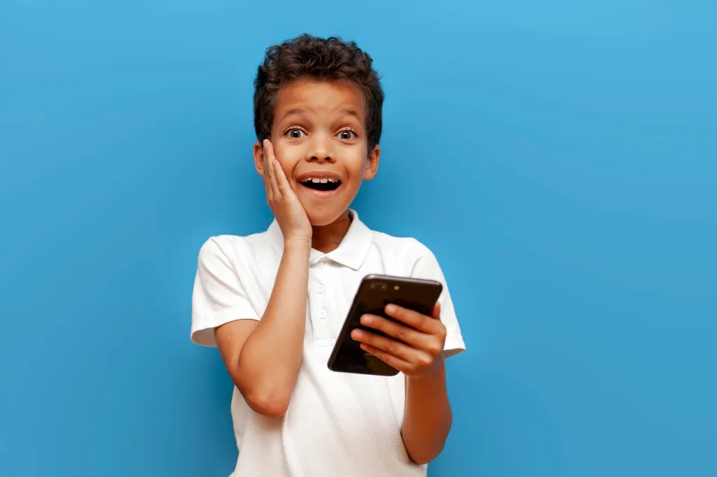 Shocked boy on phone. 