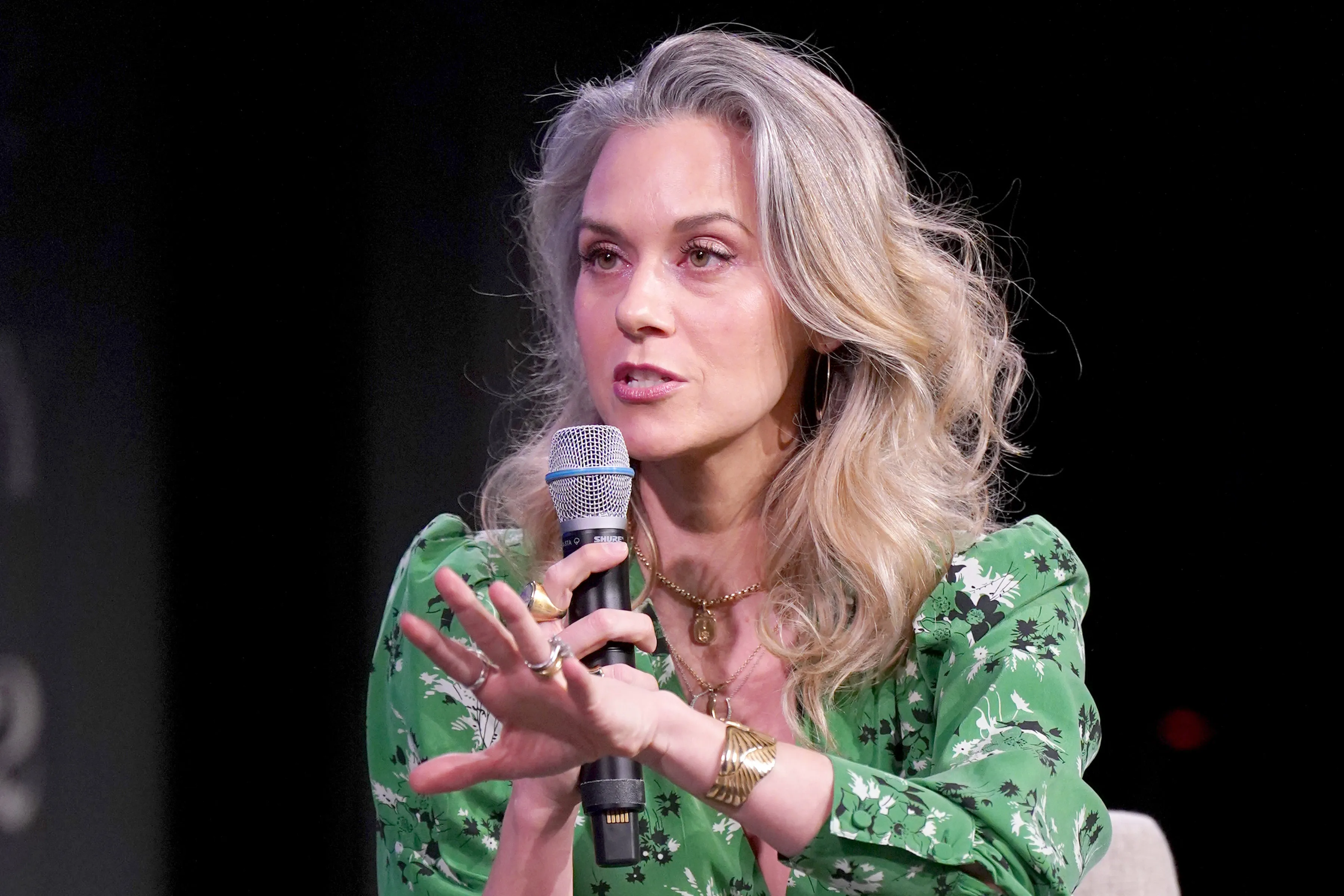 Hilarie Burton speaking into a microphone.