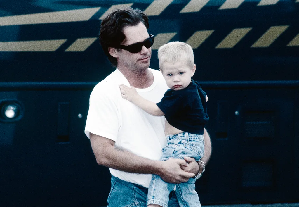 Singer/songwriter John Mellencamp holding his son Hud.
